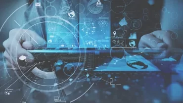 Close-up of hands using a futuristic laptop with digital interfaces.