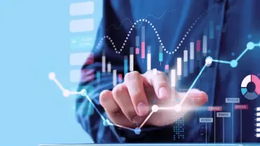 Person touching a digital financial chart with graphs and data.